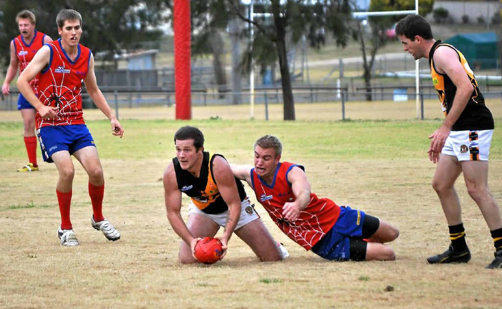 Redback Andrew Bardsley tackles Tiger James Hartley at Roddie’s Oval. Redback Andrew Bardsley tackles Tiger James Hartley at Roddie’s Oval.